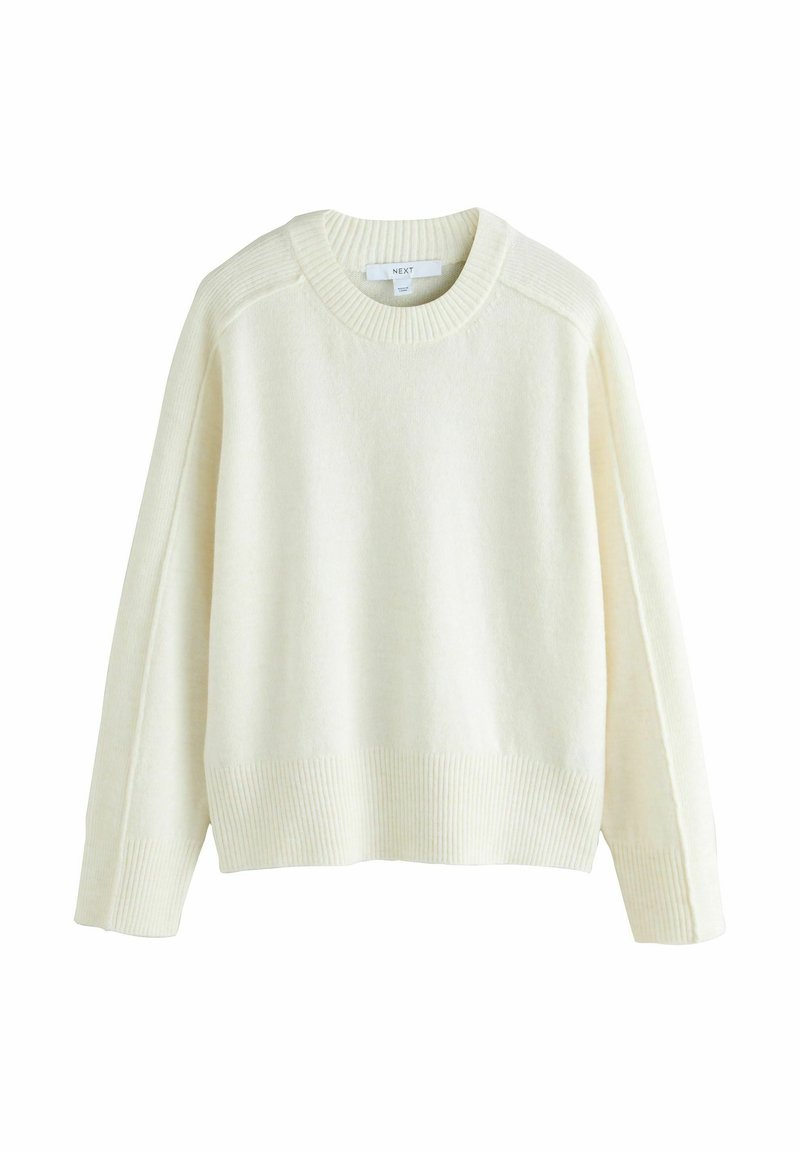 Beigefarbener Pullover aus weichem Strickmaterial mit runden Ausschnitt, gerippten Bündchen und Saum sowie einem überschnittenen Schulterdesign.