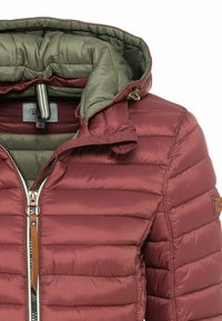 Maroon puffer jacket with a green interior, featuring a zip closure, horizontal stitching, and faux leather accents.