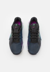 Black and blue athletic shoes with mesh upper, lock laces, purple accents, green details, and white midsole; textured pattern on the side.