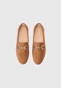 Brown suede loafers with gold-tone hardware accents, rounded toe, minimal stitching detail, and a smooth, flat sole.
