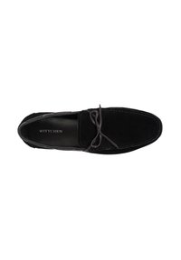 Zwarte suède moccasin schoen met een ronde neus, contrasterende stiksels en een decoratieve leren strik. Merken zichtbaar op de binnenzool.