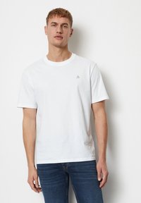 White cotton t-shirt with a crew neckline, short sleeves, and a small gray logo on the left chest. Soft texture, casual fit.