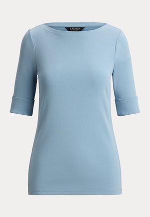 Light blue women's top with elbow-length sleeves, folded cuffs, and a rounded neckline.