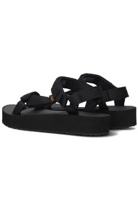 Sandalias negras con correas anchas y ajustables, una plantilla texturizada y una suela de goma gruesa para estabilidad y comodidad.