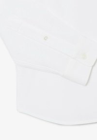 Weißes Hemd mit strukturiertem Stoff, versehen mit Knopfmanschetten und einem glatten Finish. Beinhaltet dezente Nähte und ein klassisches Design.