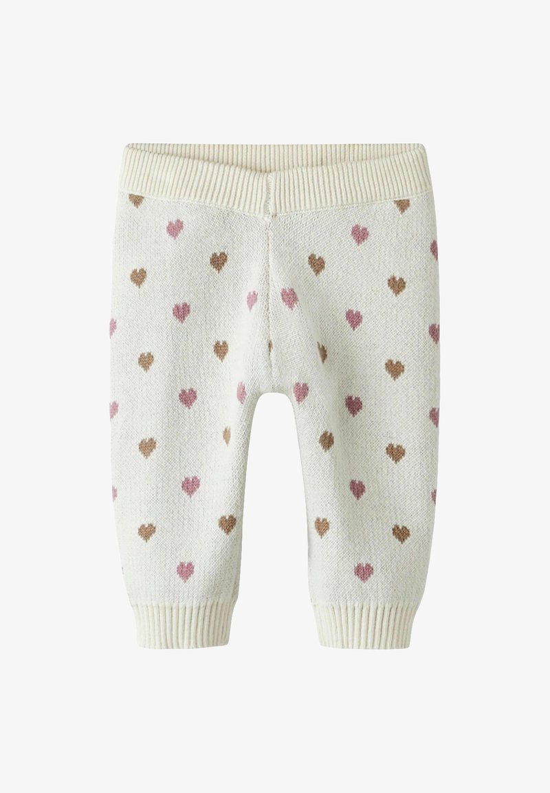 Knit baby pants in light cream with pink and brown heart patterns. Features ribbed waistband and cuffs; textured fabric.