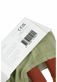 Organic cotton toy with a green body, brown limbs, and a textured surface. Includes a care label with CE and UKCA markings.