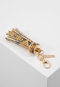 Nahkake tasakaunis kuldsed detailid, kellel on kollase, musta ja valge tooni tassi disain koos tekstuuriga mustriga ja metallist klambriga.