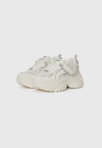 Chunky white sneakers with a textured upper, silver accents, and a decorative chain. Rounded sole design for added height and comfort.