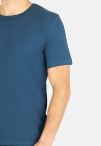 Blaues T-Shirt mit kurzen Ärmeln, Rundhalsausschnitt, weichem Stoff, dezentem Logo auf der Brust und figurbetonter Passform, geeignet für die Freizeit.