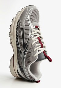 Mesh running shoe in gray with black accents and maroon lace loops. Features a padded collar and textured outsole for grip.