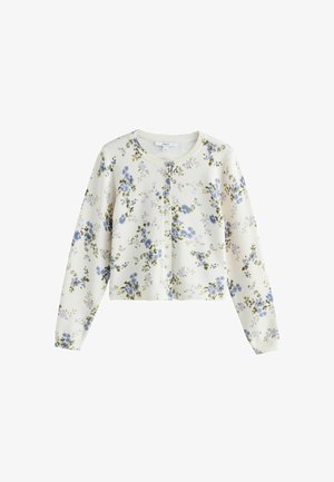 Gilet blanc à boutons avec motif floral bleu et violet et manches longues, présenté sur un fond blanc uni.