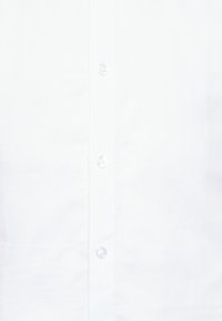 Camicia bianca in cotone liscio, con una chiusura a bottoni dotata di bottoni rotondi e trasparenti, e una trama fresca e pulita.