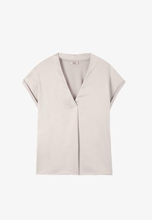 Blusa beige chiaro a maniche corte con scollo a V e design minimalista, distesa su uno sfondo bianco.