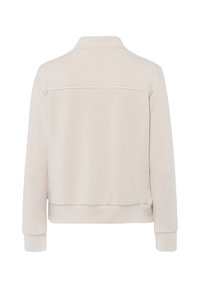 Lichtbeige sweatshirt, relaxte pasvorm, kraag, ribgebreide manchetten en zoom. Soepele textuur met een subtiele naaddetail over de rug.