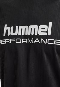 Black athletic shirt with a smooth texture, featuring vertical stripes and prominent white "hummel" and "PERFORMANCE" logos.