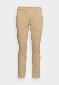 Beige bomullsbyxor med smal passform, med knäppning, sidofickor och minimala sömdetaljer för en ren look.
