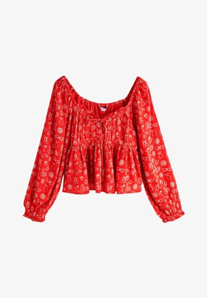 Sarkana blūze ar gariem pūkainiem piedurknēm, ar plecu atsegumu un savākto detaļu. Rakstā iekļauti balti abstrakti motīvi.