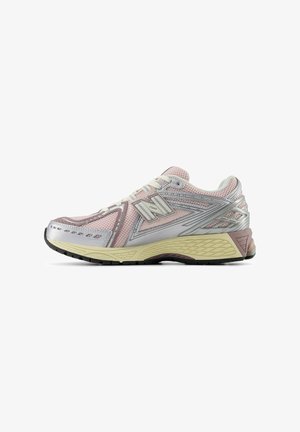 Light pink and silver running shoe with mesh upper, rubber sole, and textured accents. Features a lace-up design and supportive rear.
