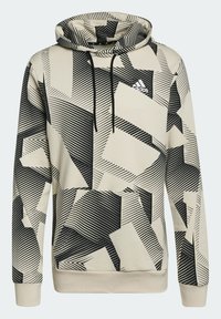 Sweat à capuche beige avec des motifs géométriques diagonaux noirs, poche kangourou à l'avant, cordons noirs et petit logo Adidas blanc sur la poitrine.