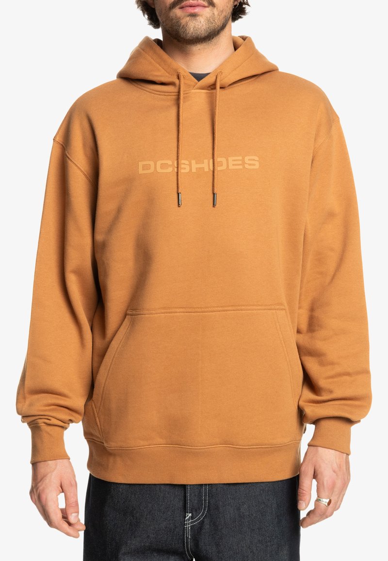 Bruine hoodie met een kangoeroezak, verstelbare trekkoorden en een subtiel logo op de borst. Zachte stof met ribbels aan de mouwen en onderkant.