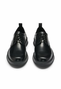 Black leather shoes with smooth texture, round toe, and lace-up design. Features a padded collar and flexible black rubber sole.