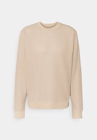 Beżowa dzianinowa bluza z teksturowanym wzorem, okrągłym dekoltem oraz ściągaczami na mankietach i u dołu. Prosty, luźny krój.