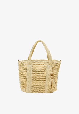 Kudottu oljesta valmistettu kangaskassi vaaleassa beigen sävyssä, jossa on kaksi tukevää kantokahvaa, koristeellinen tupsu ja luonnollinen puukoriste. Avoin yläpalo design helpottaa pääsyä.