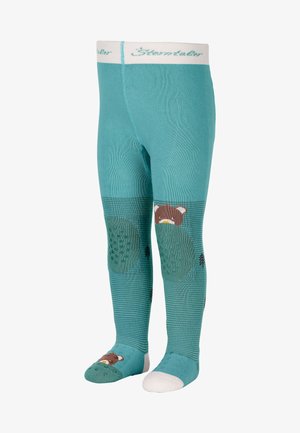 Turquoise children's tights with textured areas, featuring a bear design, tree patterns, and contrasting white soles. Soft, stretchy material.