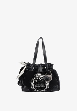 Black tote bag with faux suede and leather accents, featuring white decorative text, silver hardware, and a bow detail on one side.
