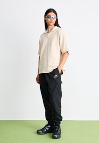 New Balance CLASSICS JOGGER - Tracksuit bottoms - black