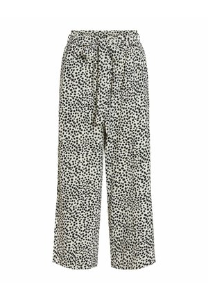 Pantalon large taille haute à pois noirs irréguliers sur fond blanc, avec une ceinture assortie en tissu nouée à la taille.