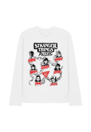 White long-sleeve shirt with black and red "Stranger Things Tales from '85" graphic featuring illustrated character faces and names from the series.