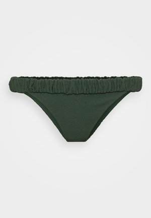 Chilo verde dintr-un material texturat, cu o talie volănaș, și un croi clasic. Captuseală interioară netedă pentru confort.