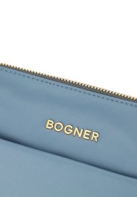 Light blue nylon pouch with gold hardware and the embossed "BOGNER" logo. Features a smooth texture and a zip closure.