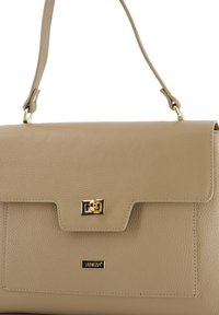 Beige leather handbag with a textured finish, gold hardware, and a magnetic clasp. Features a detachable strap and a flat front pocket.