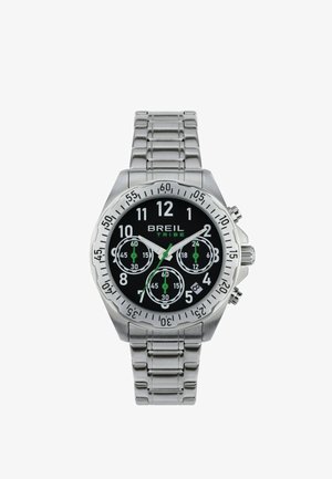 Metallisk chronograph ur med en sort urskive, sølvfarvet rustfrit stålarmbånd, store hvide timemarker og grønne detaljer på underurene.