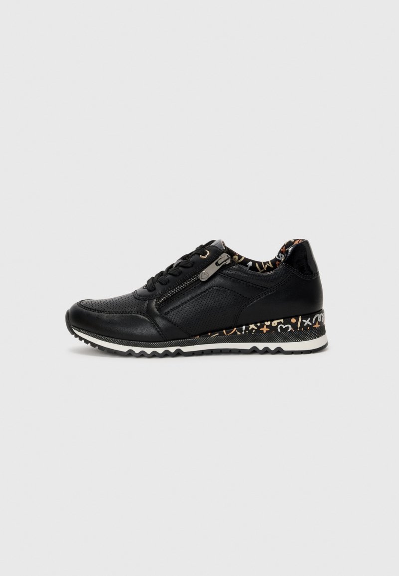Black sneakers made of leather with perforated panels, featuring a zip closure, textured sole, and a patterned accent on the heel.