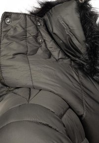 Black puffer jacket featuring a faux fur-lined hood, snap buttons, quilted texture, and a visible zipper. Material appears smooth and glossy.