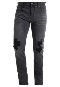 Svarta denimjeans med slim fit, med slitningar vid knäna, subtila blekningar och klassisk femficksdesign.