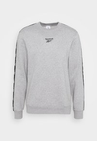Sweatshirt gris en mélange de coton, doté de longues manches, d'un col rond et de bandes latérales noires avec un logo Reebok sur la poitrine.