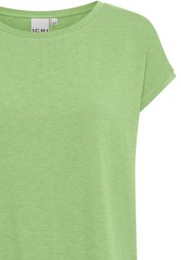 Camiseta verde de manga corta con cuello redondo, fabricada con un tejido suave y texturizado. Presenta un patrón jaspeado sutil y un diseño sencillo.
