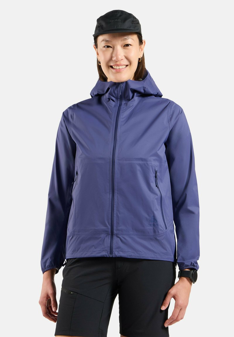 Lightweight purple jacket with a hood, front zipper, and side pockets. Smooth texture; worn with black shorts and a black cap.