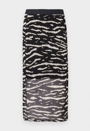 Svart-hvitt skjørt med sebramønster, gjennomsiktig design og elastisk midjebånd. Stoffet har en glatt tekstur og et bølget mønster.