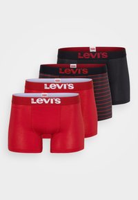 Fyra kalsonger från Levi's: två enfärgade röda, en svart med röda ränder och en enfärgad svart. Varje par har en bred midjeband med röd logotyp.