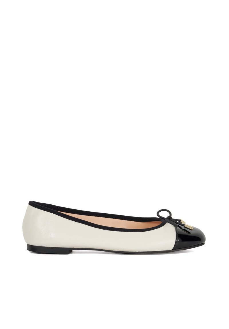 Ballet flat shoe with a cream leather upper, black patent leather toe cap, black trim, and decorative bow with small gold hardware.
