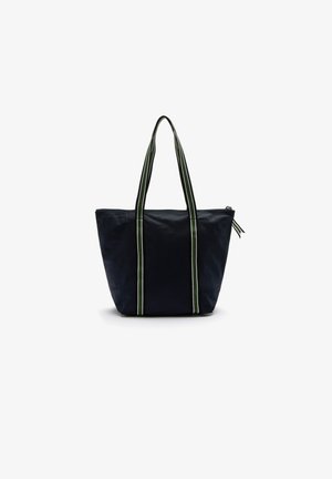 Sac fourre-tout bleu marine avec de longues anses doubles, présentant des rayures vertes, blanches et noires, fermeture éclair et fond large pour le transport.