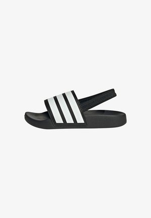 Black slide sandals with a wide strap featuring three white stripes. Made of synthetic material, with a textured upper and a contoured sole.