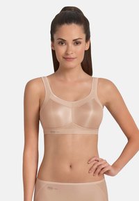 Beige non-padded bra with wide straps, mesh panels, and a seamless design. Features a comfortable band and a soft texture.