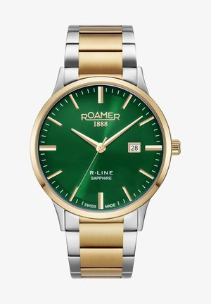 Apskates pulksteņi ar zaļu ciparnīcu, zeltītām stunda marķieriem un datuma rādi. Sudraba un zelta nerūsējošā tērauda siksniņa ar pulētu apdari.